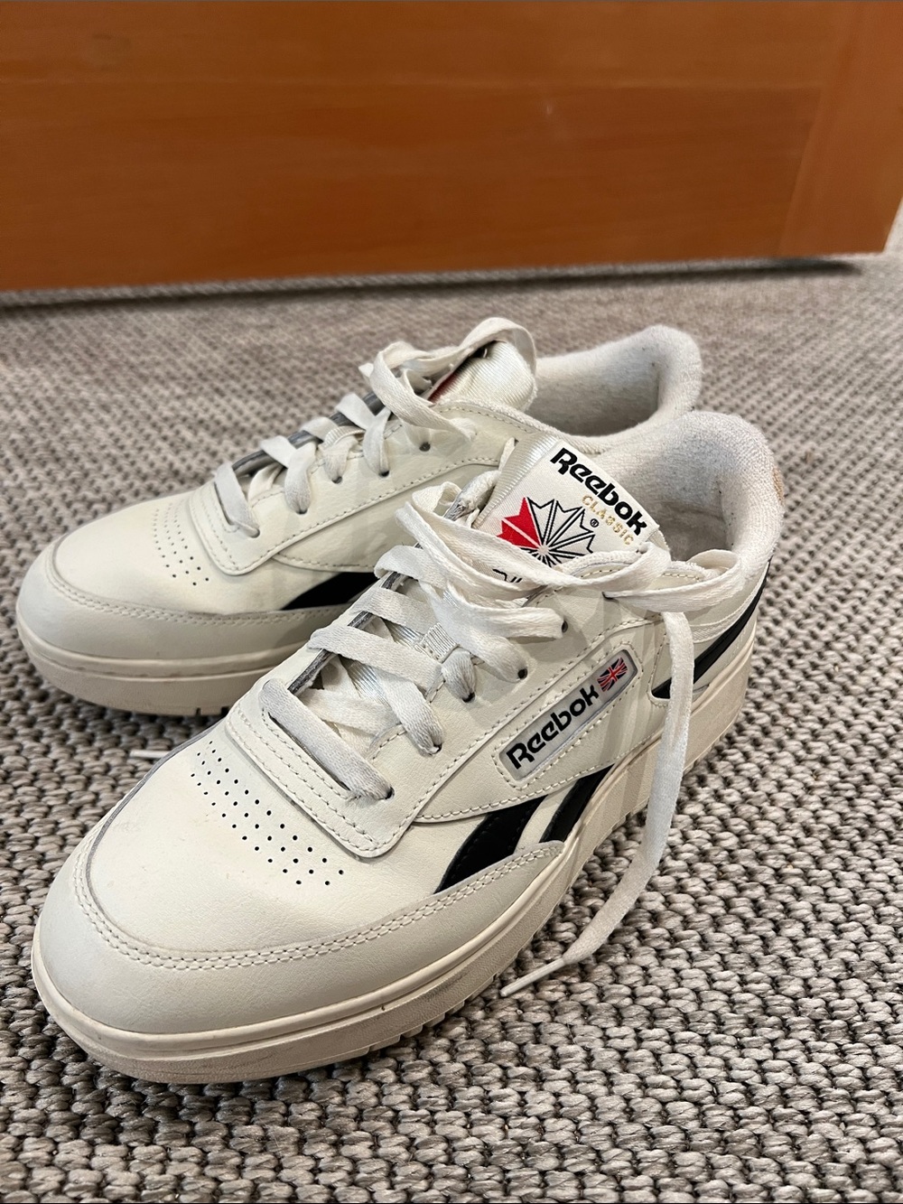 Reebok White Leather Sneakers with Black Stripes and Red Logo Accent